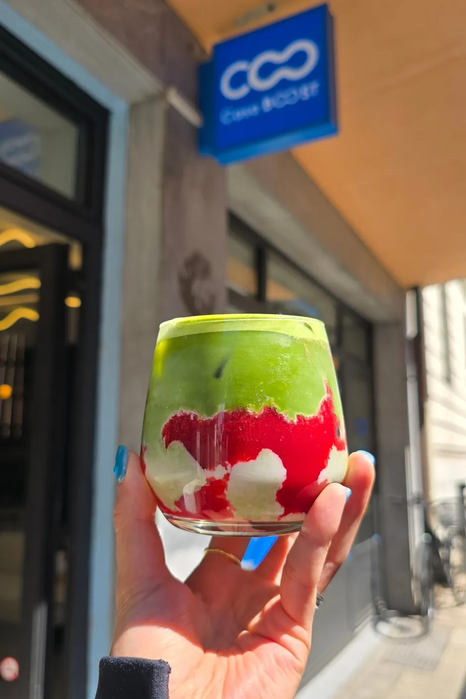 A matcha outside CASA BOOST Eaux-Vives, under the sign