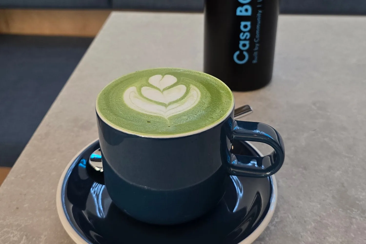 A matcha latte and a CASA BOOST flask at The Well Lab, Eaux-Vives
